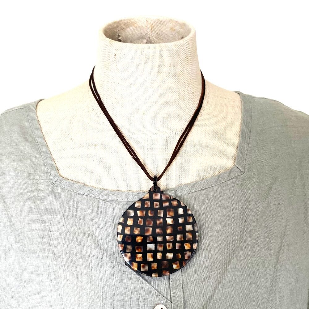 Black Circular Pendant With Inlaid Cubes on a Black Strand Necklace